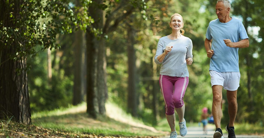 Active and healthy aged couple running in natural environment on summer morning; blog: Everyday Habits to Keep Kidneys Healthy