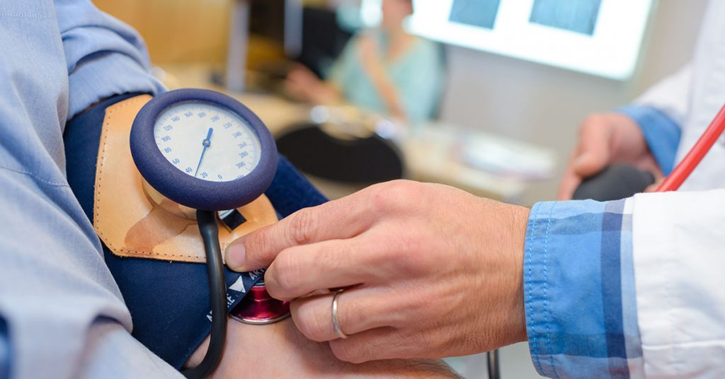 Closeup of blood pressure being taken; blog: Why Managing Blood Pressure Is Essential In A Pandemic