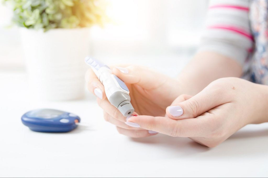 A diabetic taking a reading of their blood sugar