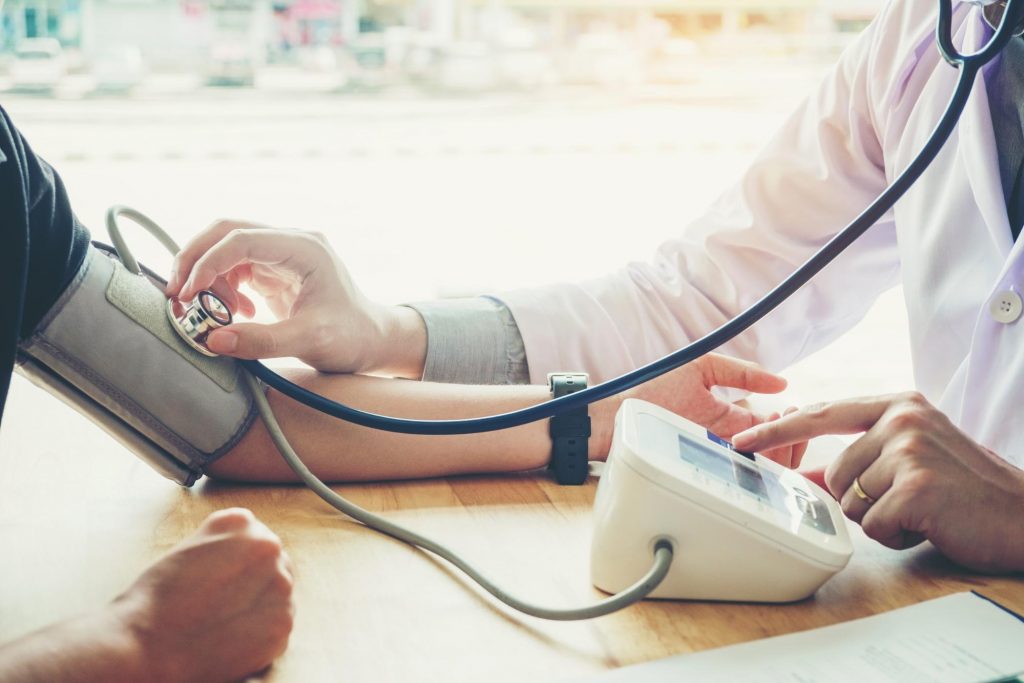 doctor taking a blood pressure reading