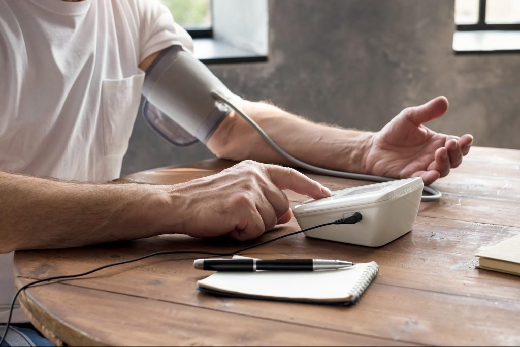 A man taking his own blood pressure reason to find the cause of a sudden blood pressure spike