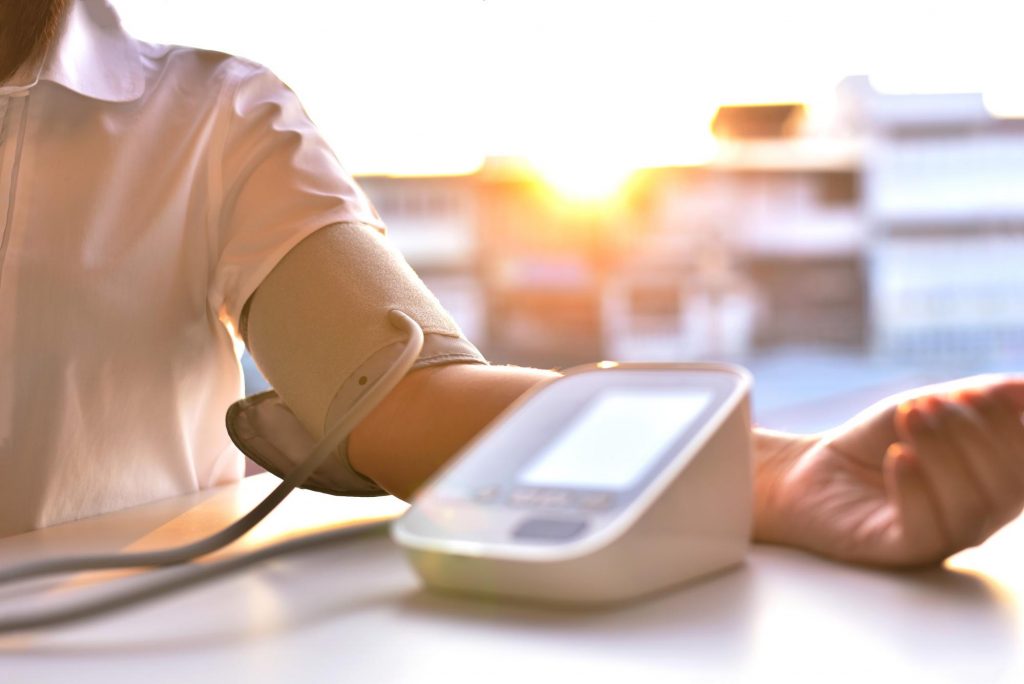 A person monitoring their blood pressure at home