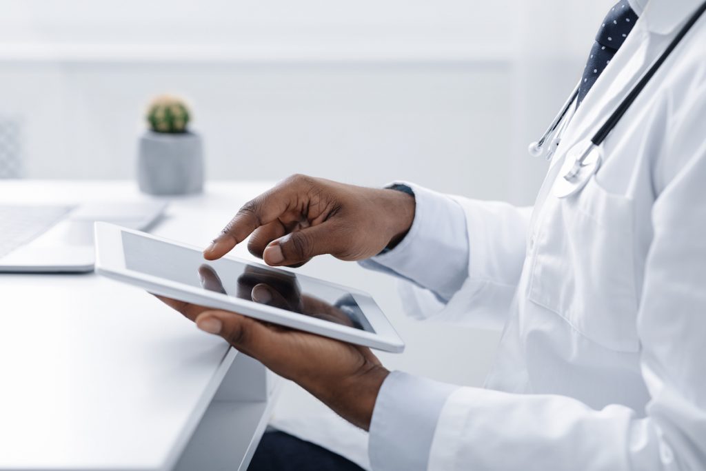 a nephrologist working on a tablet