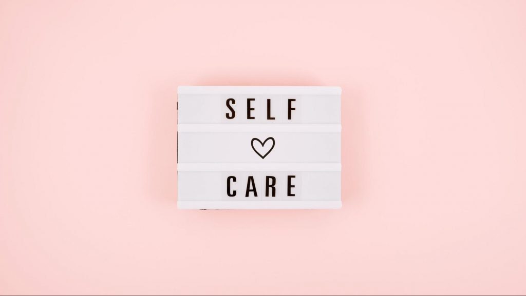 self care sign on a pink background
