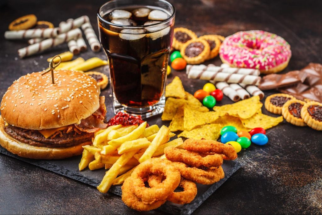 A picture of Top Foods to Avoid When You Have CKD including sweets, fried food, candy, and soda.