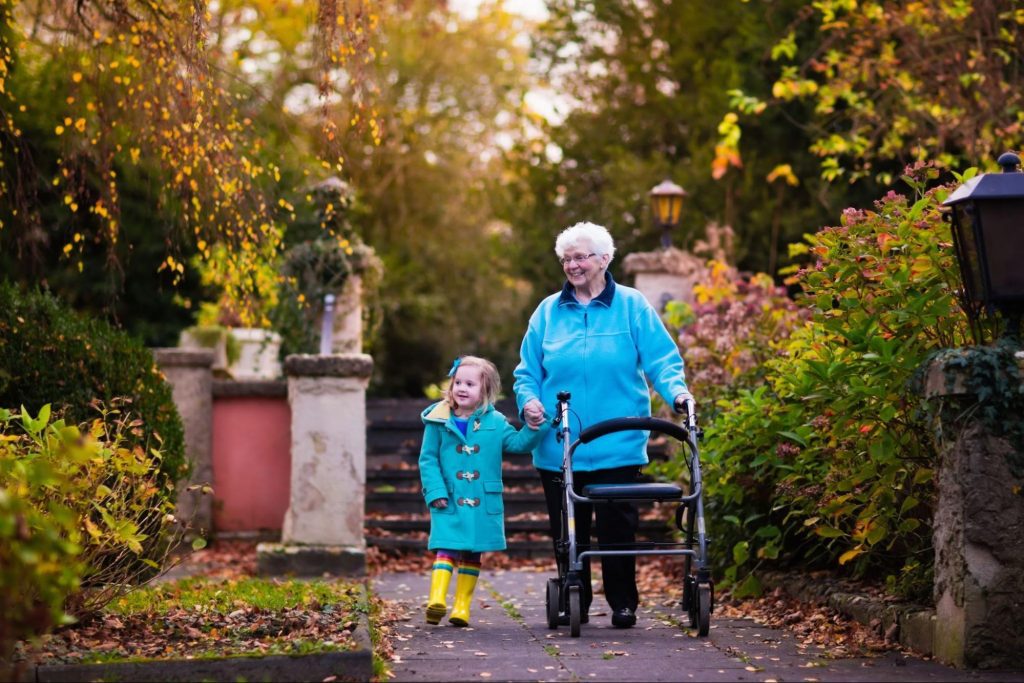 a grandmother living with CKD and her grandchild walking in the autumn