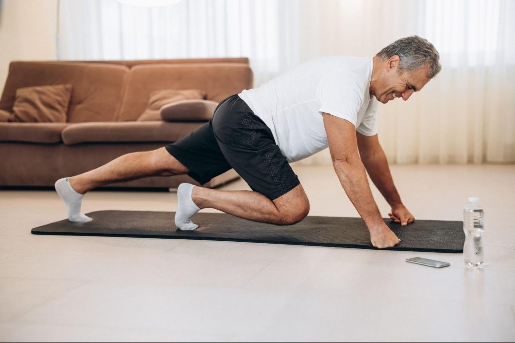 A man doing a mat exercise to illustrate one of the Best Indoor Exercises To Elevate Your Heart Rate